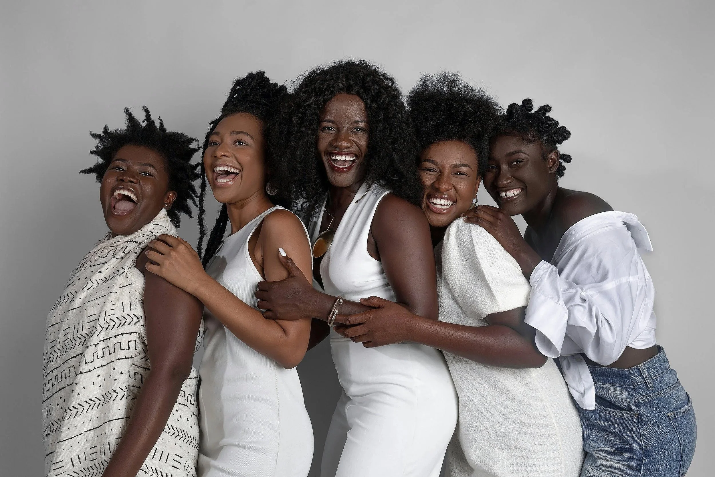 Multigenerational group of smiling & laughing black women