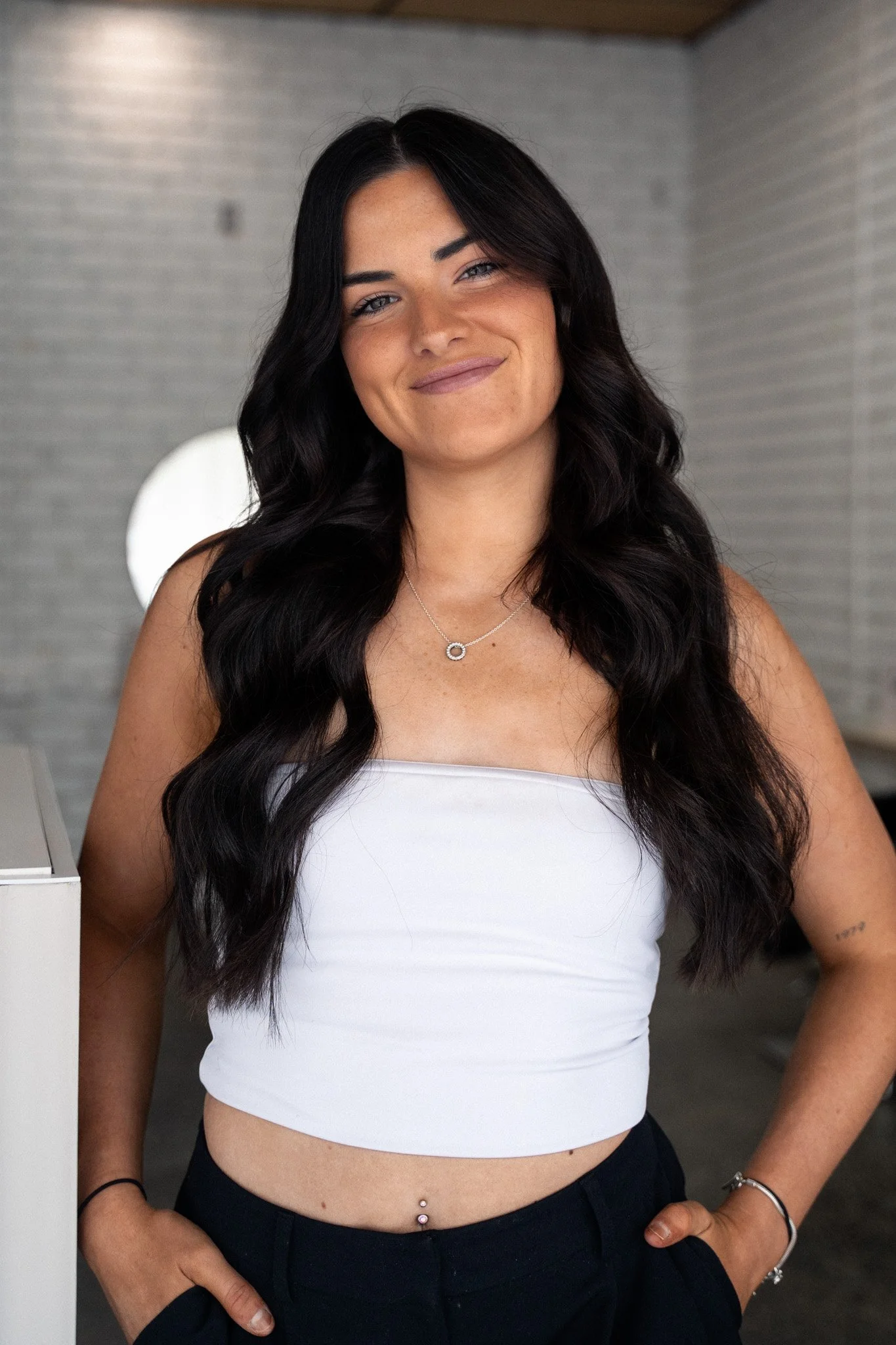 Capelli Hair Studio logo in black script and uppercase font