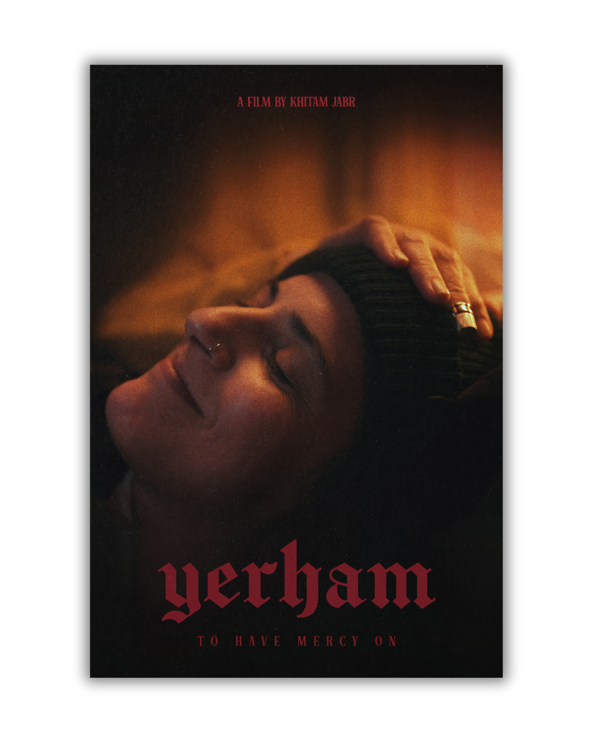 A woman with closed eyes and a nose ring, wearing a beanie, lying down with her hand on her head, on a poster for the film "Yerham" by Khitam Jabr. The poster has dark tones and red text.