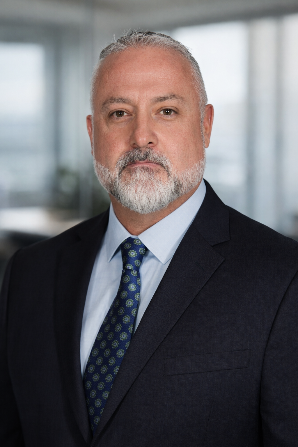 A man with a suite and a american flag backdrop