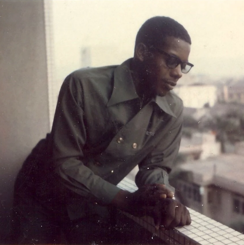 Louis Raynor leaning on a balcony