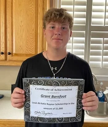 2022 scholarship recipient, Grant Barefoot, posing with his award certificate