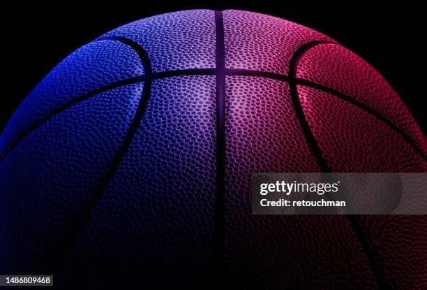 Close-up of a basketball with red and blue lighting effects.