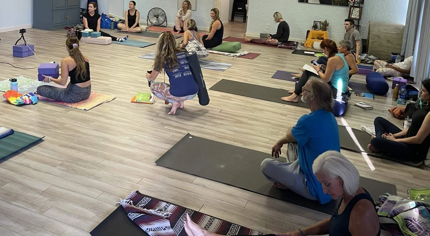 yogis sitting in a studio in yoga teacher training