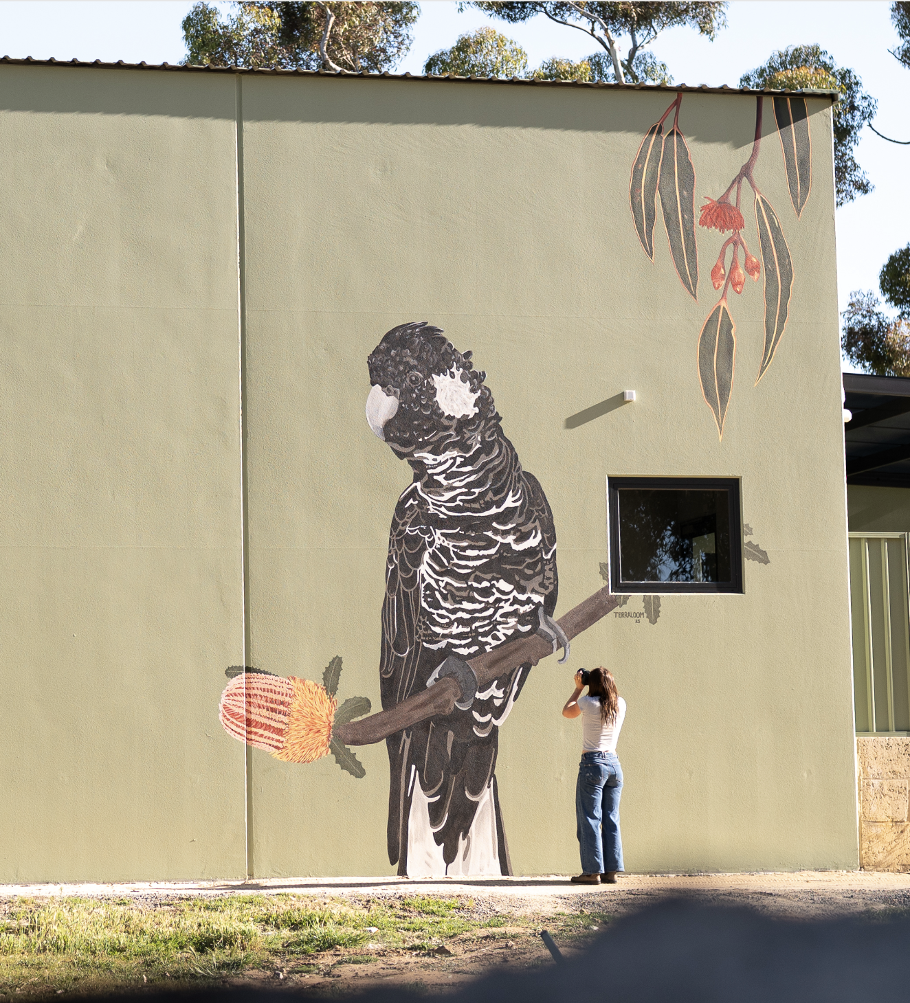 Mural Artist Annabelle Denniss Taking Photo of her Mural at the Royal Fremantle Golf Course
