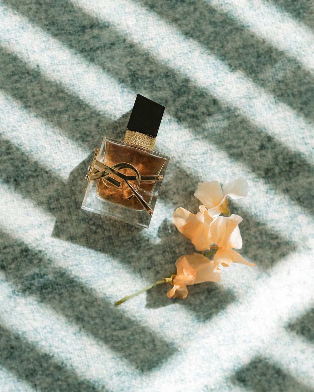 Perfume bottle and gold ring bridal detail