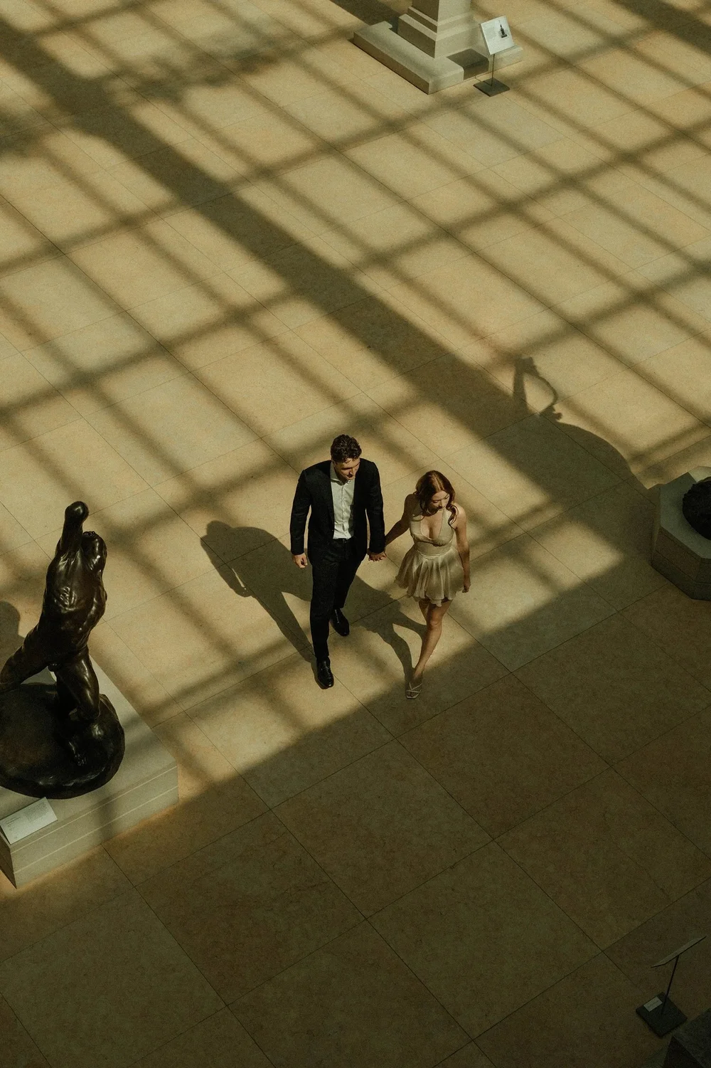 Couple walking through a New York museum, wedding film still