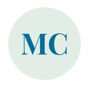 A circular logo with light background and dark blue letters 'MC' in the center.