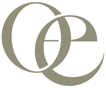 Close-up of a stylized monogram with interconnected letters 'C', 'e', and 'o' in beige against a black background.