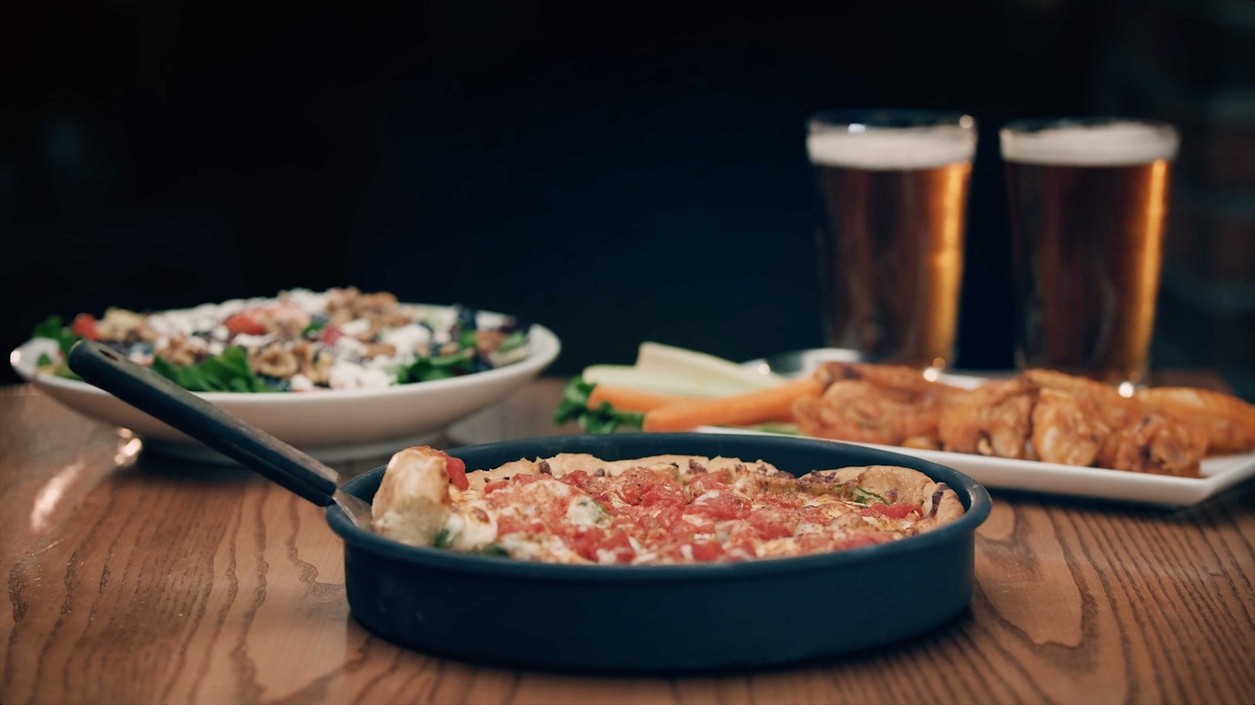 Restaurant table with pizza and craft beer for food brand content