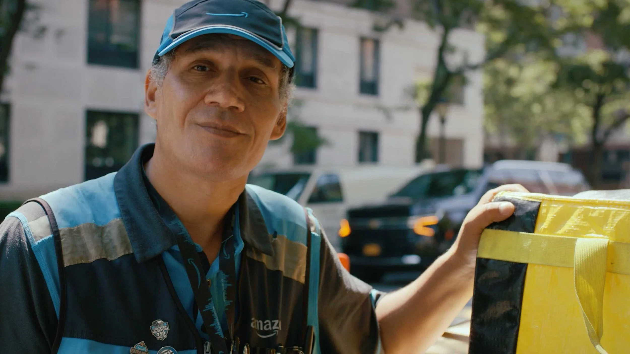 Amazon delivery associate looks at the camera in a documentary video