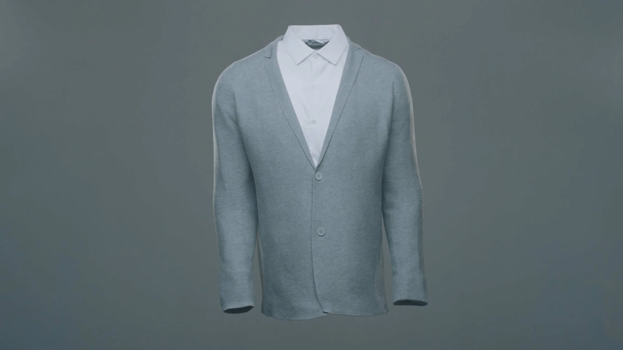 A gray 3d printed sweater by Ministry of Supply floats on a studio backdrop in a product video