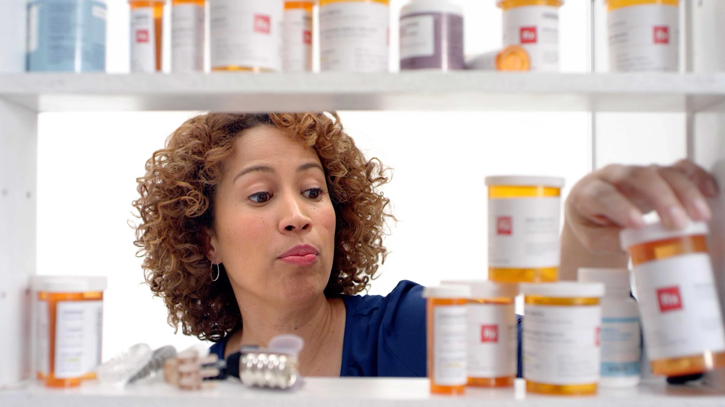 Patient reviewing prescription medication bottles at home