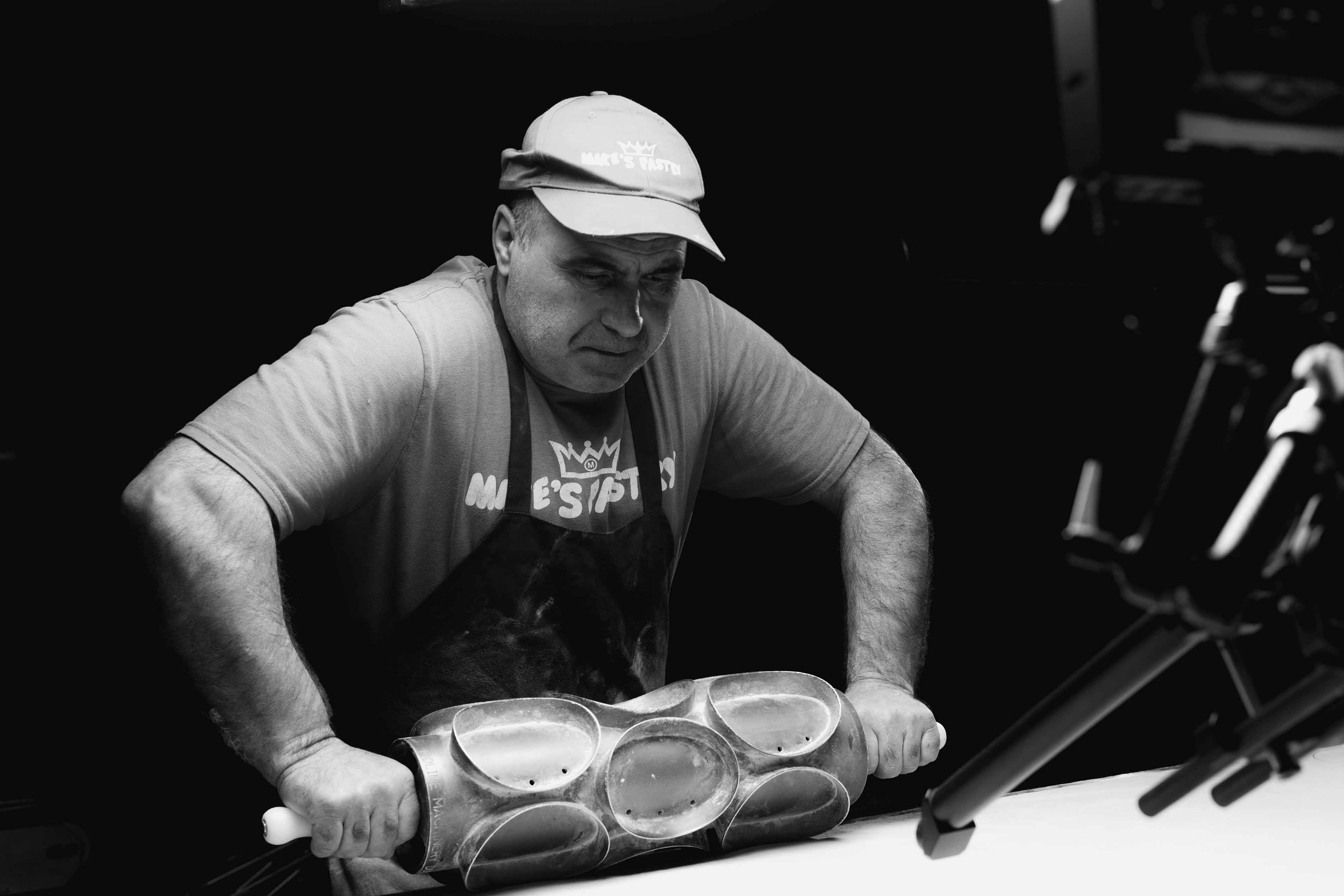 Mikes Pastry Boston cutting cannolis