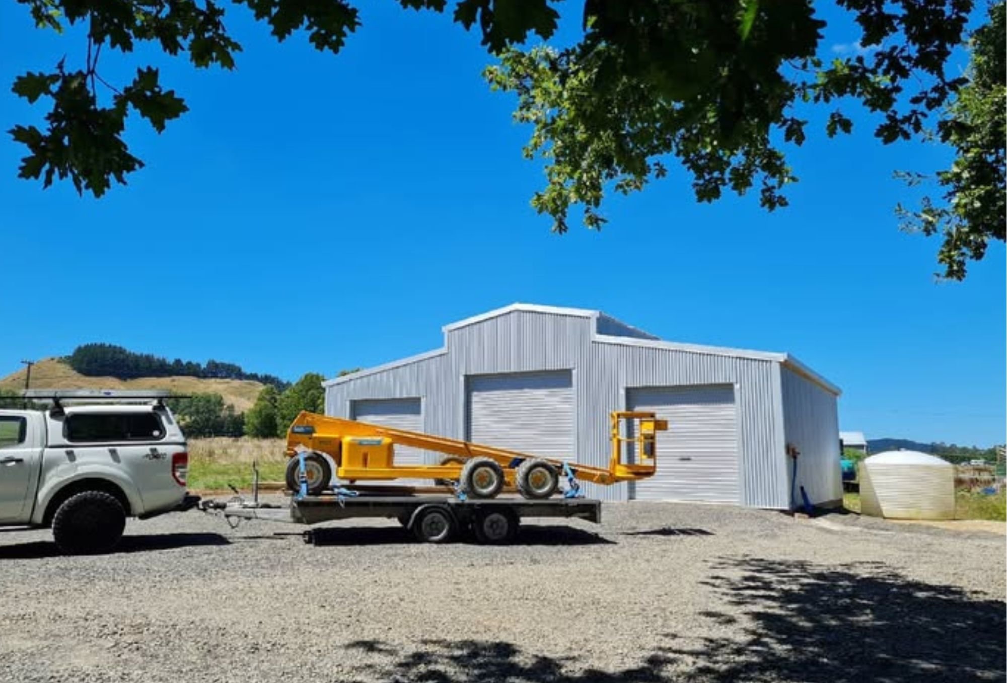 Hydralader and Ute. 2 bay wooden pole shed. American style barn in Waihi , Katikati, Aongatete. Barn for boats and machinery. Waihi Coromandel area.
