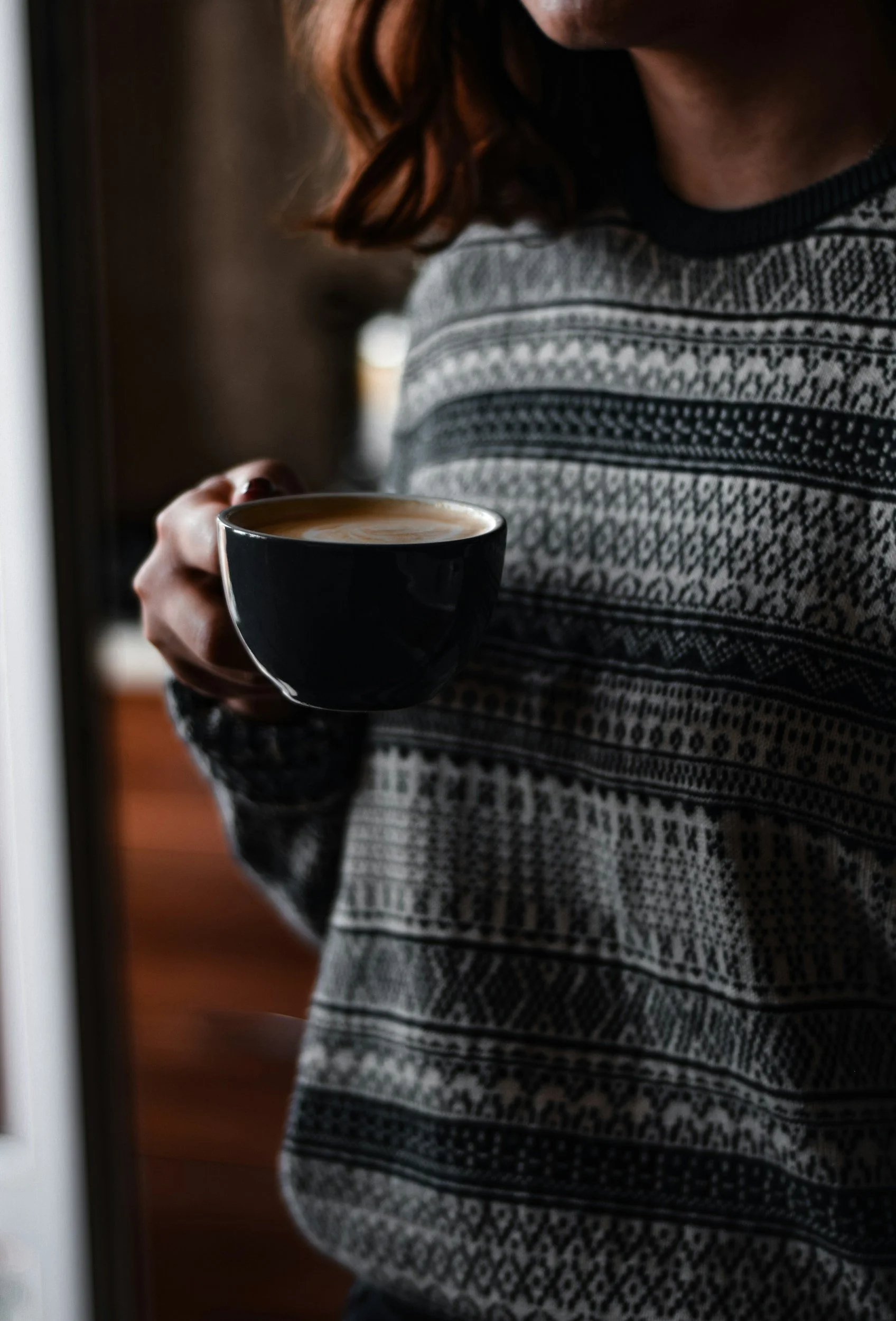 Woman holding coffee feeling calm after going through therapy to help with her anxiety