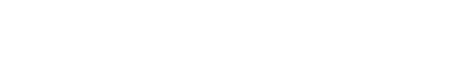 En person sitter på en benk og leser en bok i en park.