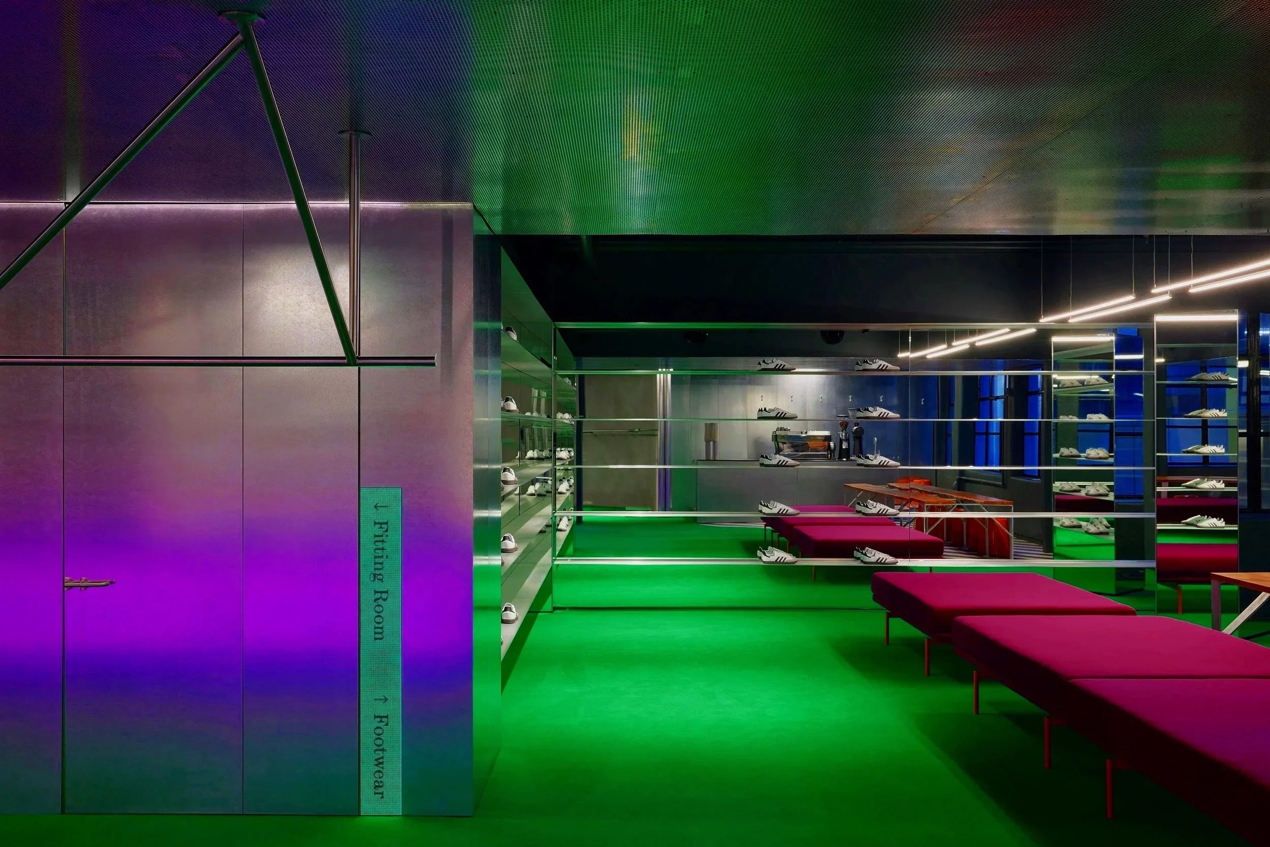 Neon-lit shoe store with green carpet, purple seating benches, and glass shelves displaying sneakers.