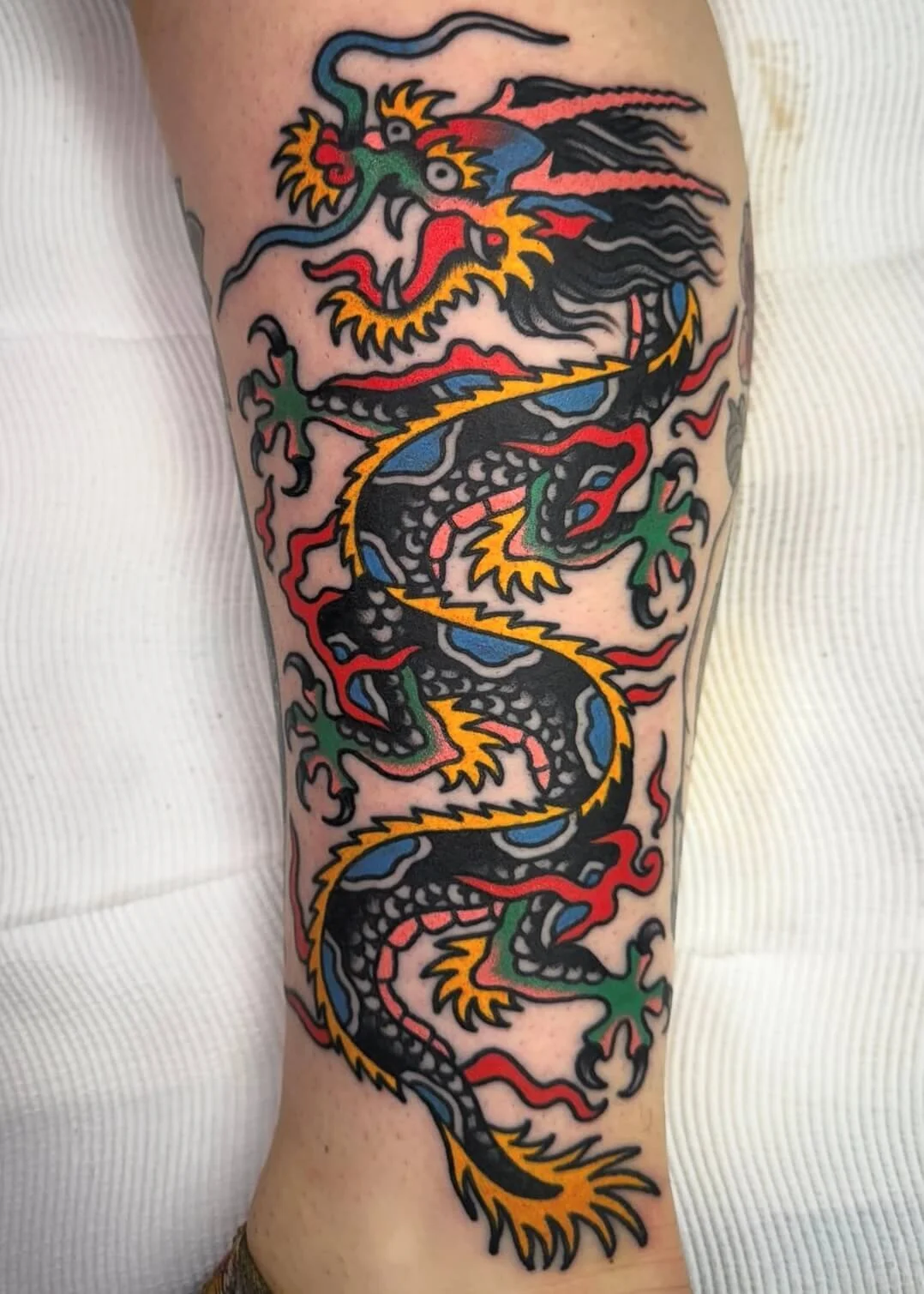 Colourful trad freehand dragon by expert artist