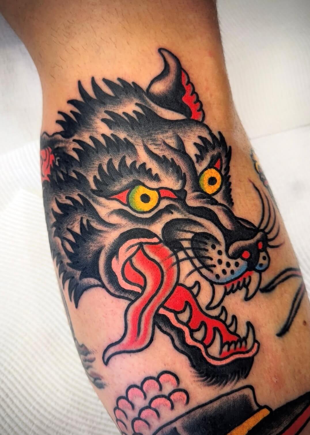 Trad wolf head tattoo for men in Sydney