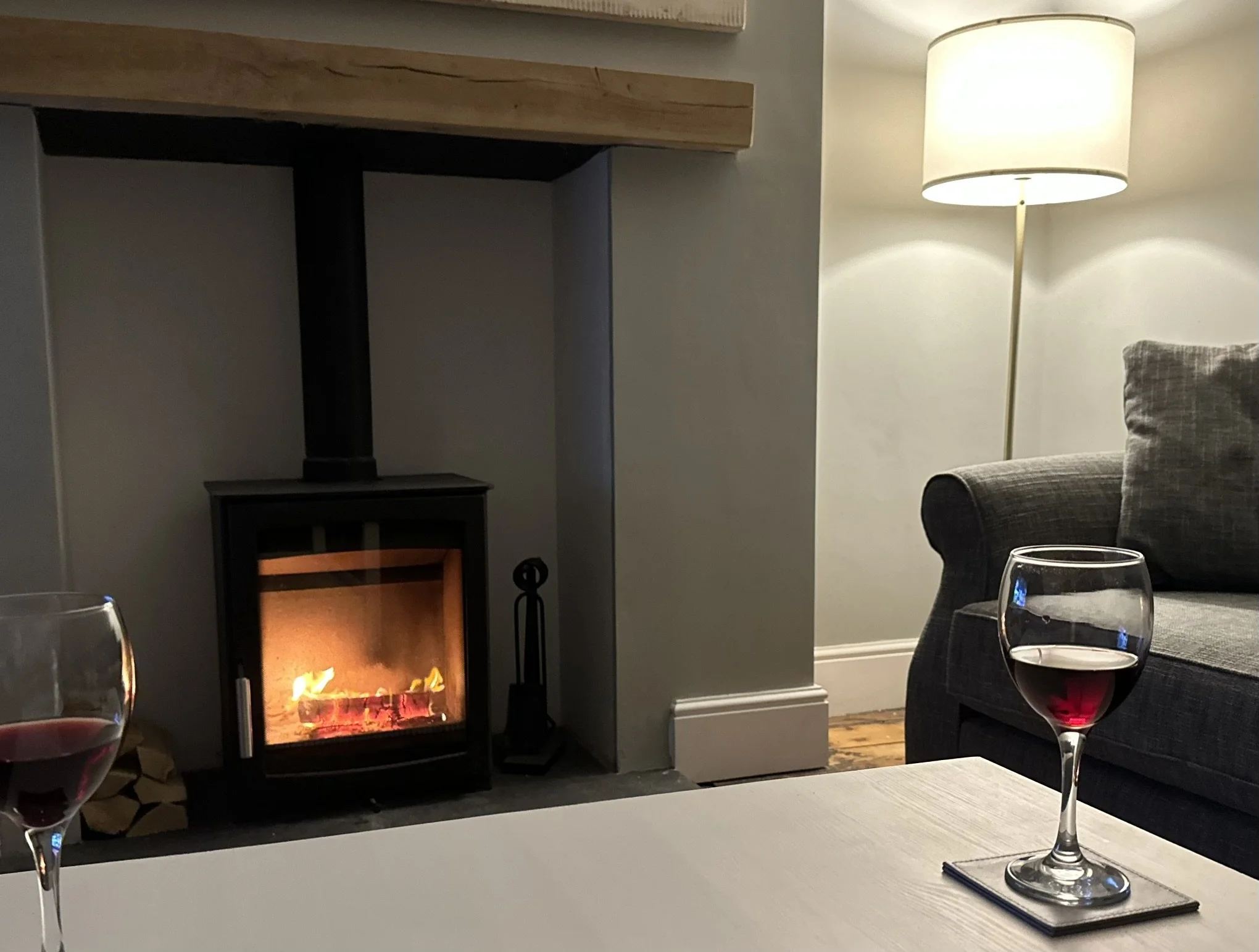 As evening falls, pour a glass of wine, switch on the fire, and unwind in the comforting warmth after a day by the sea.