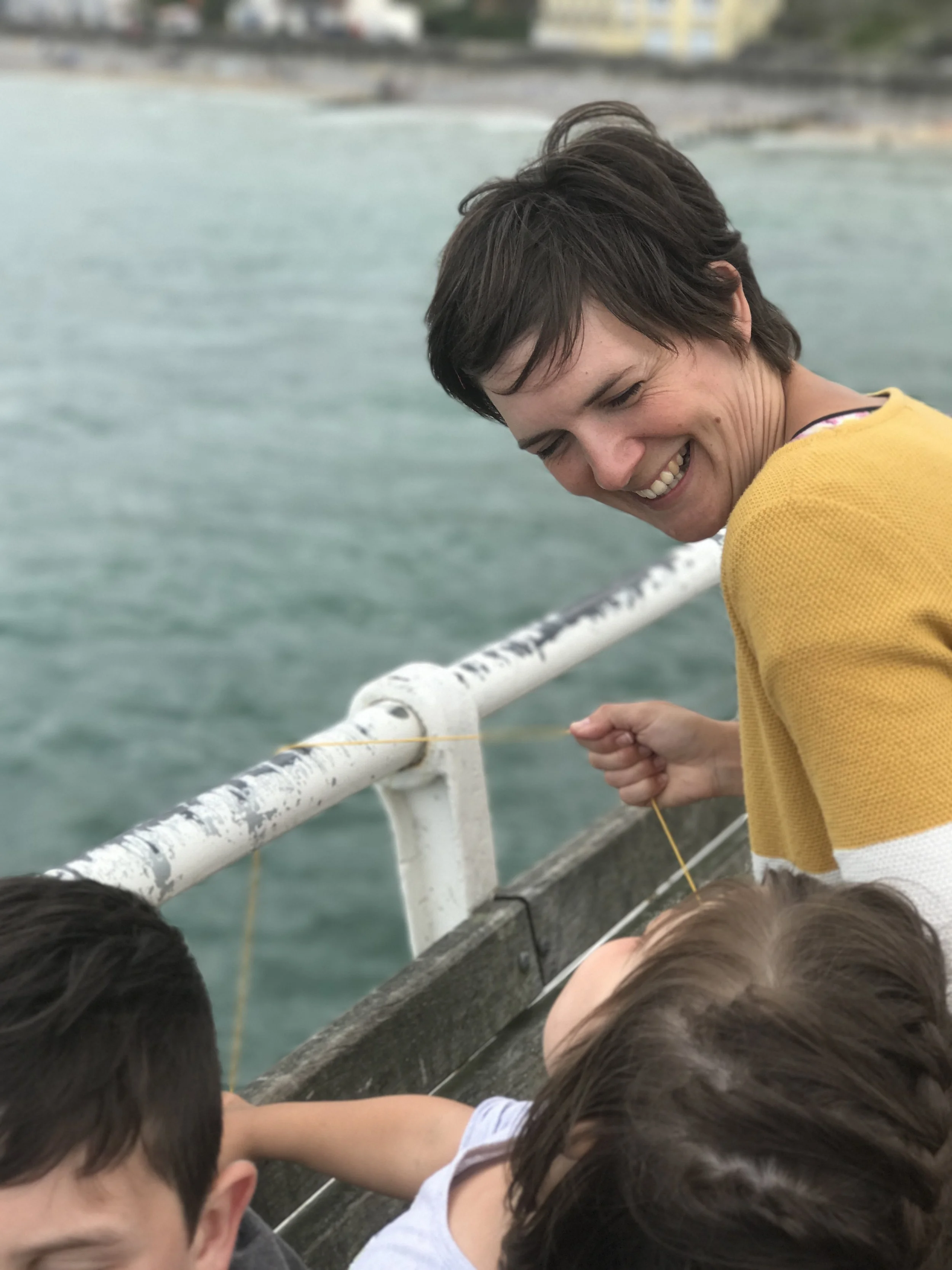 Trying crabbing at Cromer Pier, showing the children how to do it