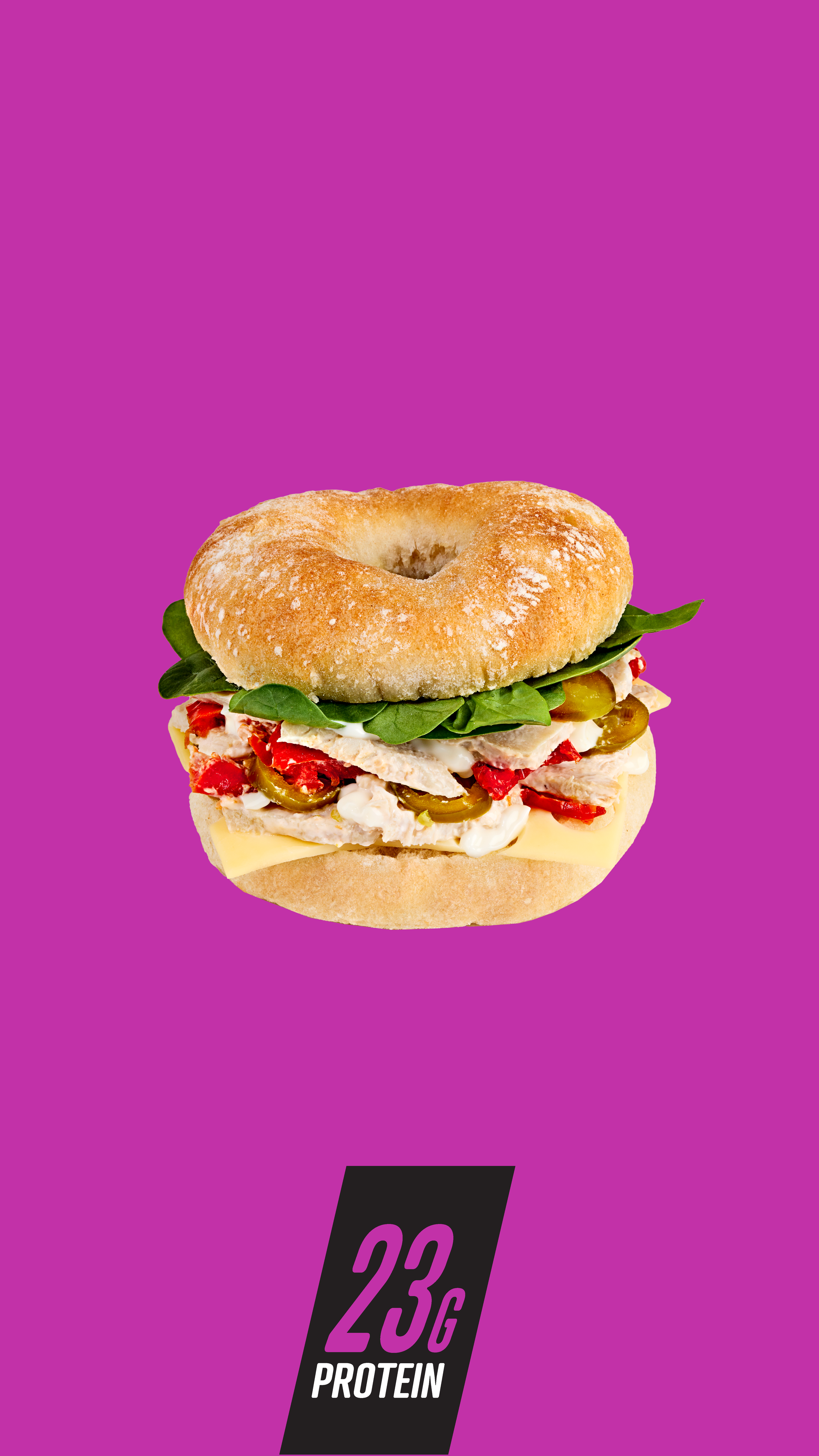 Sandwich bagel with spinach, sliced chicken, jalapenos, red peppers, cheese, and sauce, on purple background with text '23g Protein'.