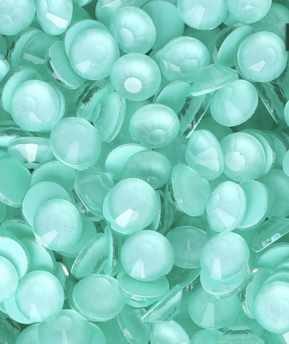 Close-up of numerous light blue or turquoise plastic marbles or beads.