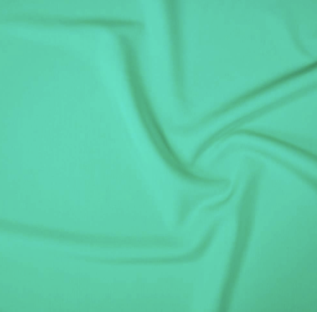Abstract green fabric with soft folds and wrinkles.