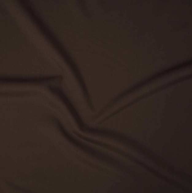 Close-up of a brown fabric surface with stitched seams.