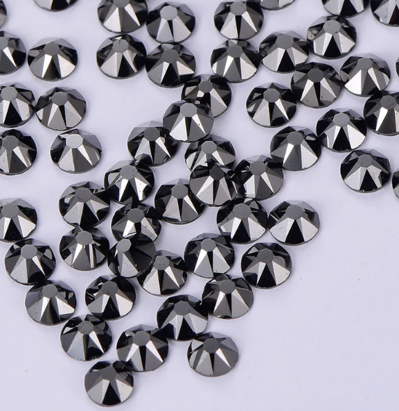 A horizontal silver bracelet adorned with multiple rows of small multicolored rhinestones on a white background.