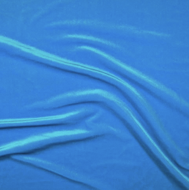 Close-up of blue fabric with folds and creases.
