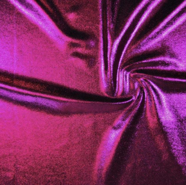 Close-up of a vibrant pink and purple shiny fabric with a swirling pattern.