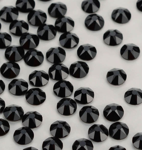 A silver bracelet encrusted with clear gemstones on a white background.