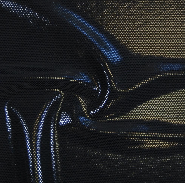 Close-up of crumpled shiny black fabric with reflections of light.