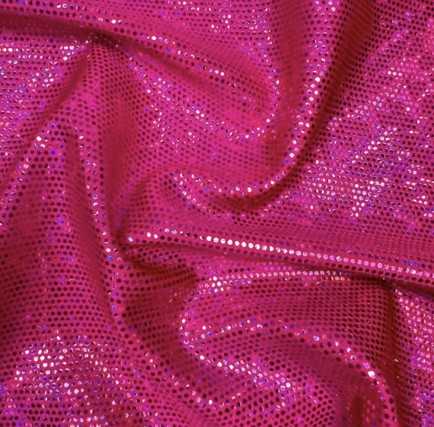 Close-up of pink fabric covered in shiny sequins, with some folds and wrinkles.