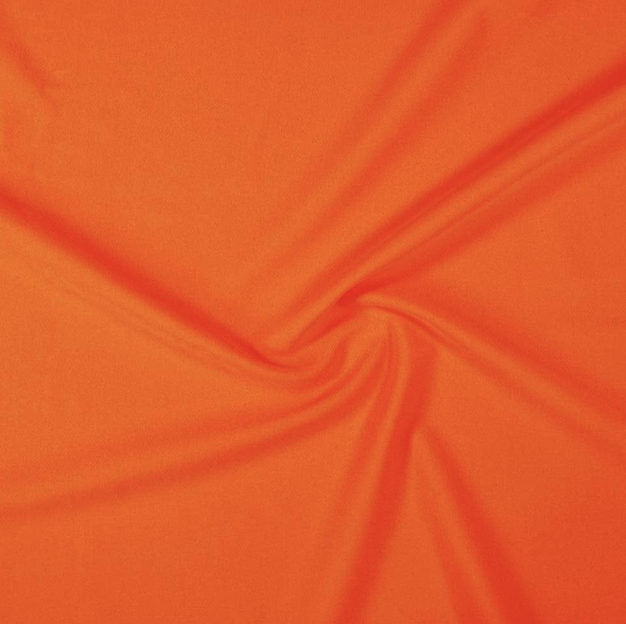 Close-up of orange fabric with a twisted pattern.