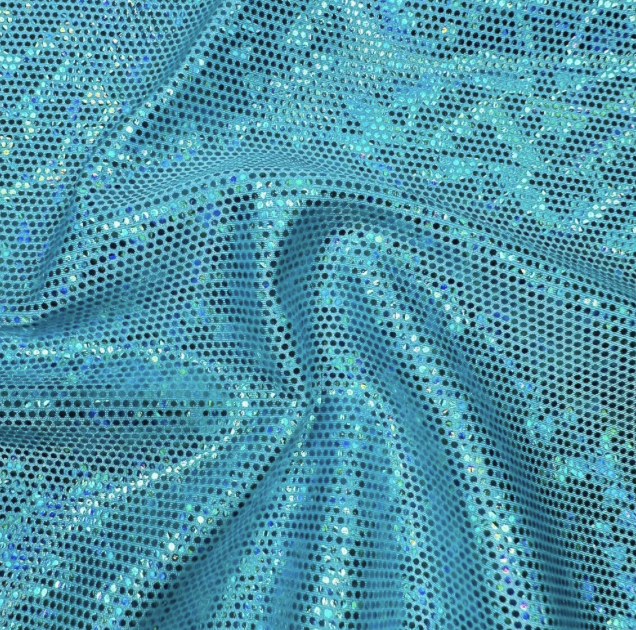 Close-up of blue fabric with iridescent sequins creating a shimmering, dotted pattern.