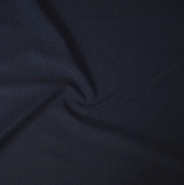 Close-up of dark blue fabric with a subtle fold or twist.