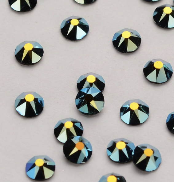 Close-up of red, textured fabric with a scale pattern design, resembling fish scales or mermaid tail pattern.