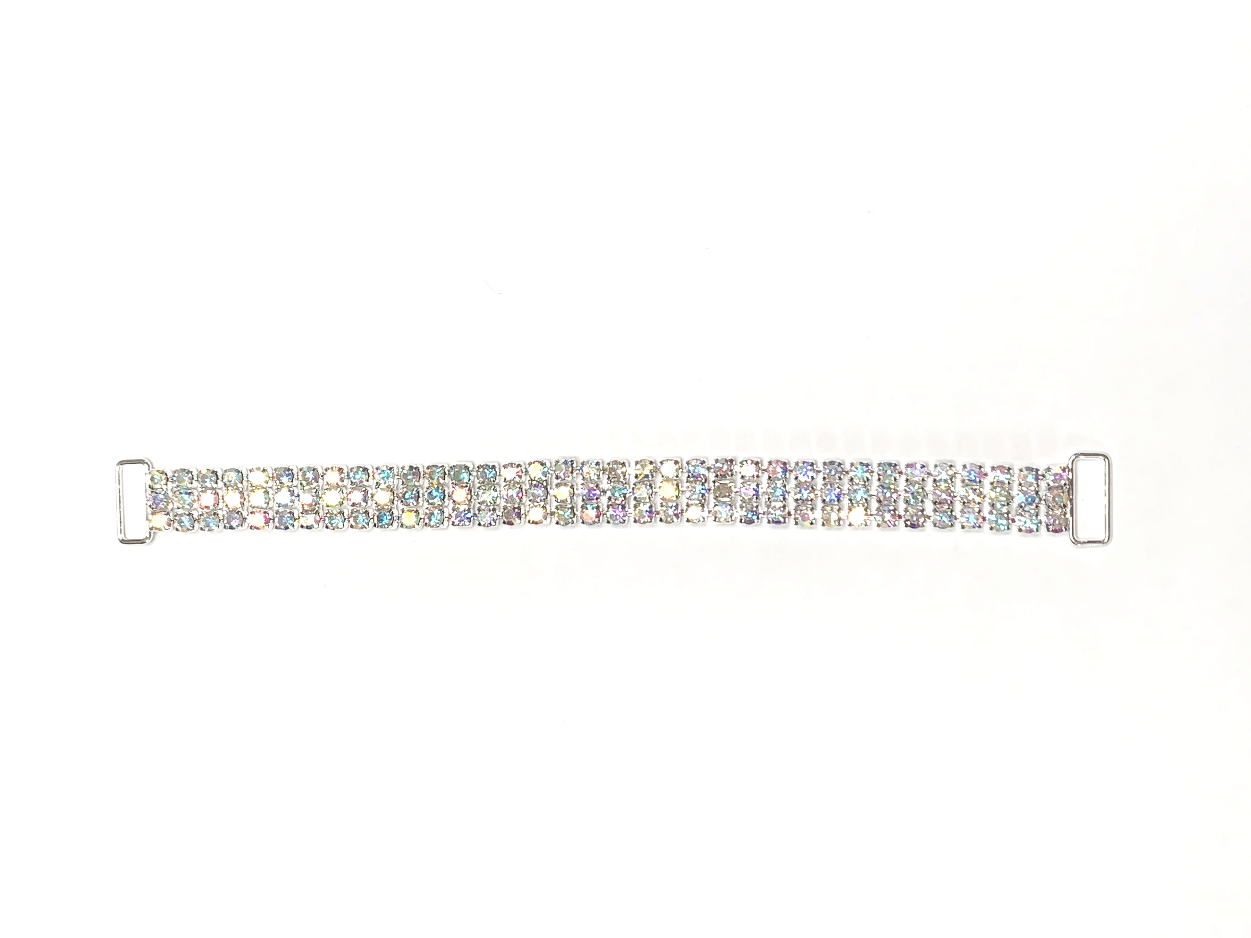 A horizontal silver bracelet adorned with multiple rows of small multicolored rhinestones on a white background.