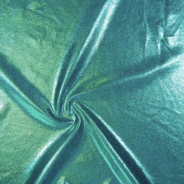 Close-up of teal-colored satin fabric twisted to create a swirling pattern.