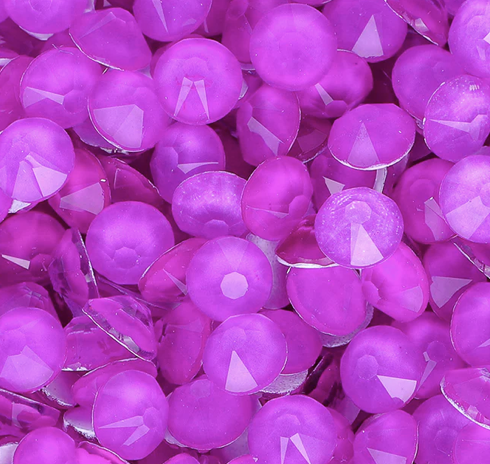 Close-up of numerous purple Mardi Gras beads with reflective surfaces.