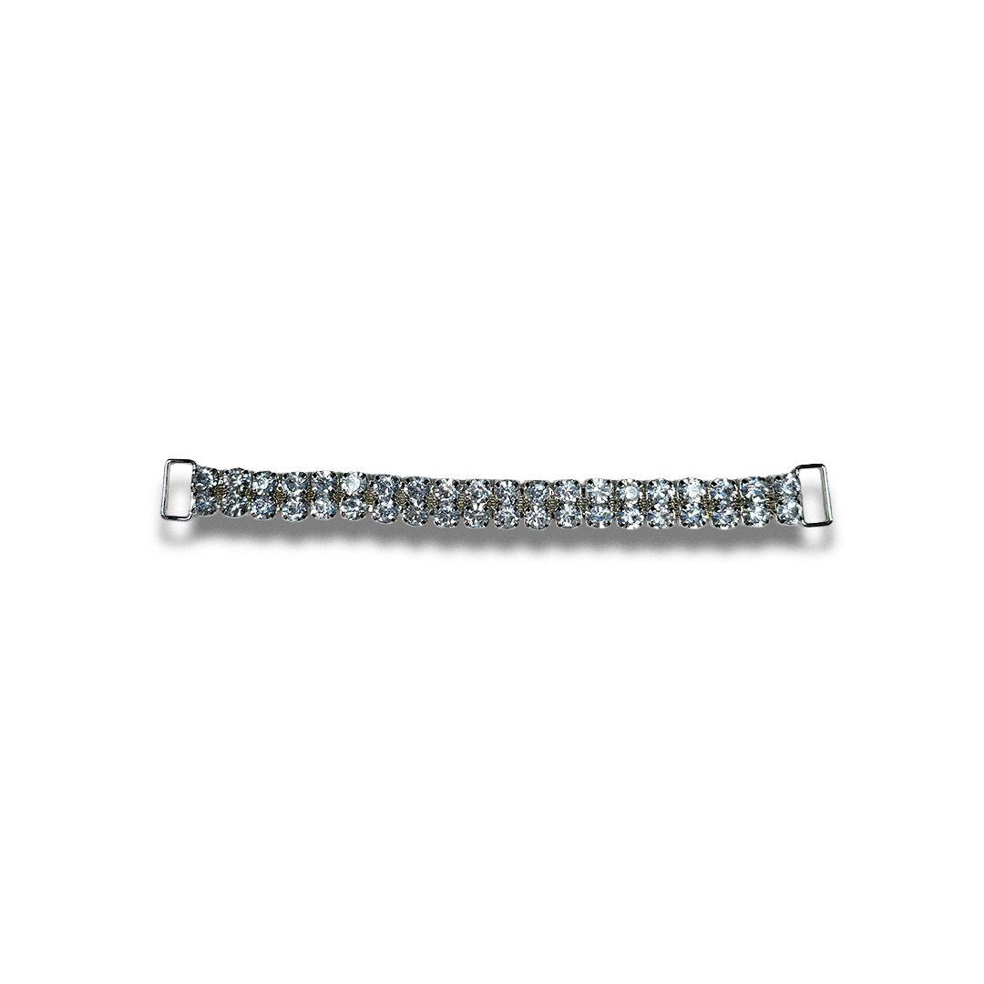 A thin silver bracelet adorned with clear sparkling stones, laid out flat on a white background.
