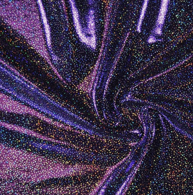 Close-up of shimmering fabric with swirling pattern of multicolored dots and purple accents.