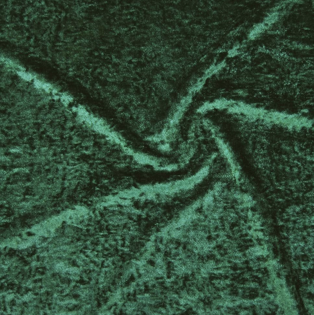 Close-up of green fabric with a swirling pattern.