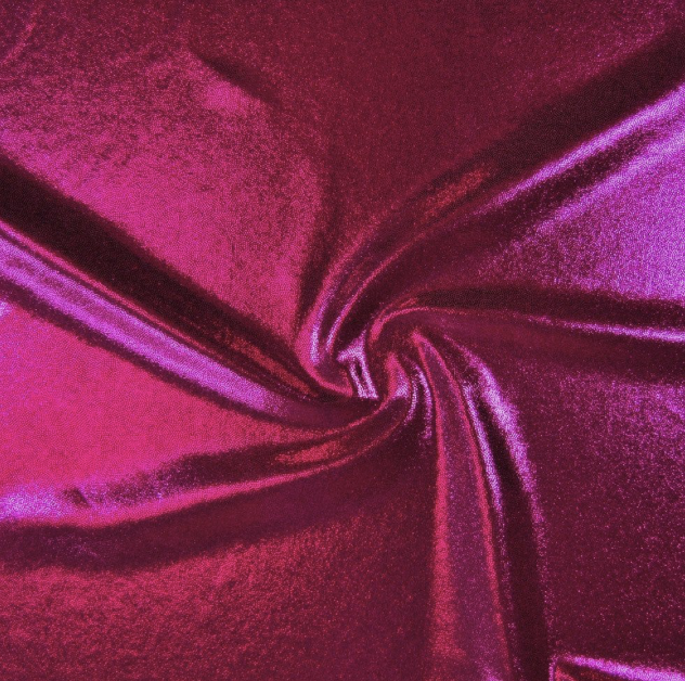 Close-up of shiny, pink satin fabric twisted to create a swirling pattern.