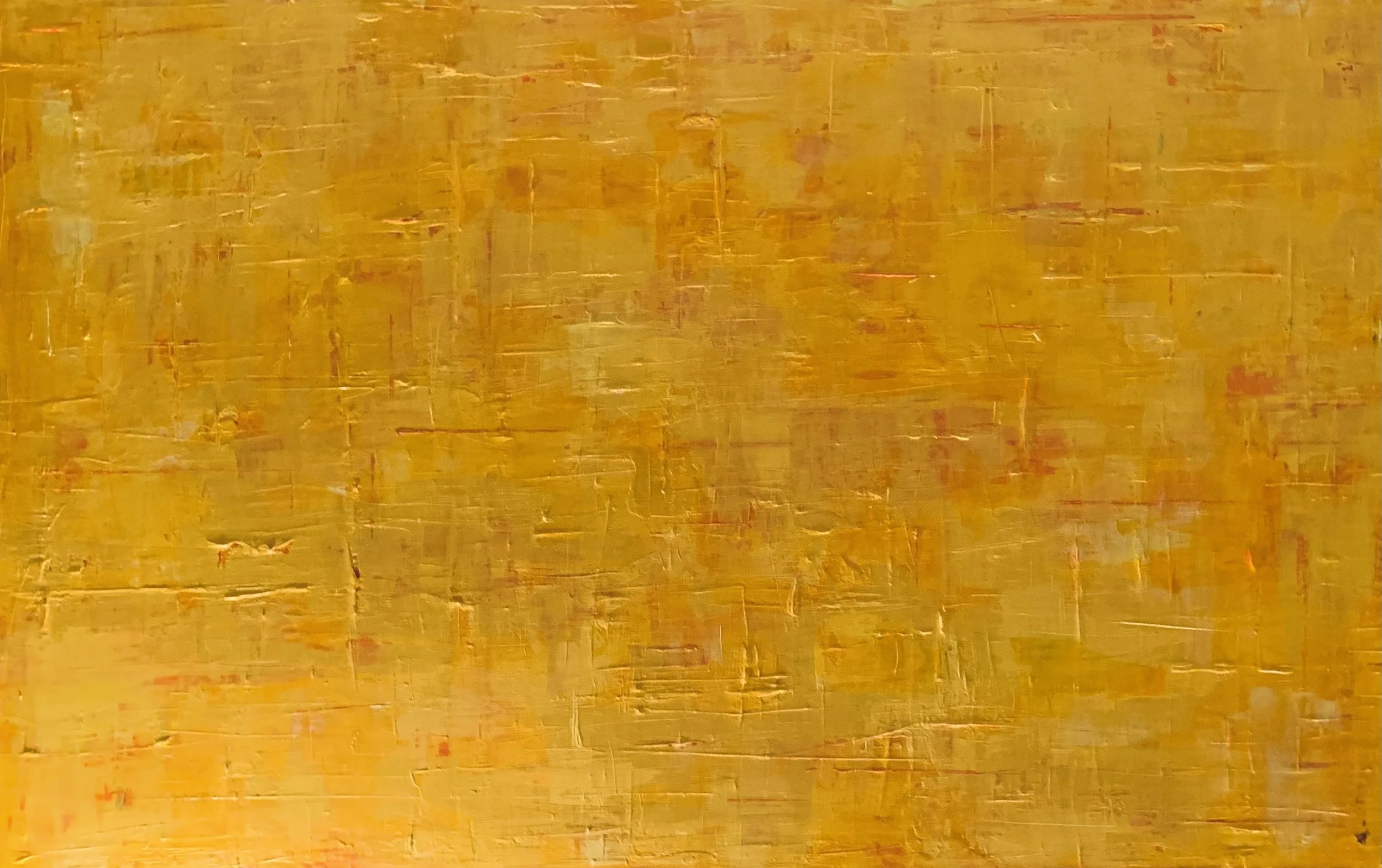Close-up of a textured surface with yellow and orange paint strokes.