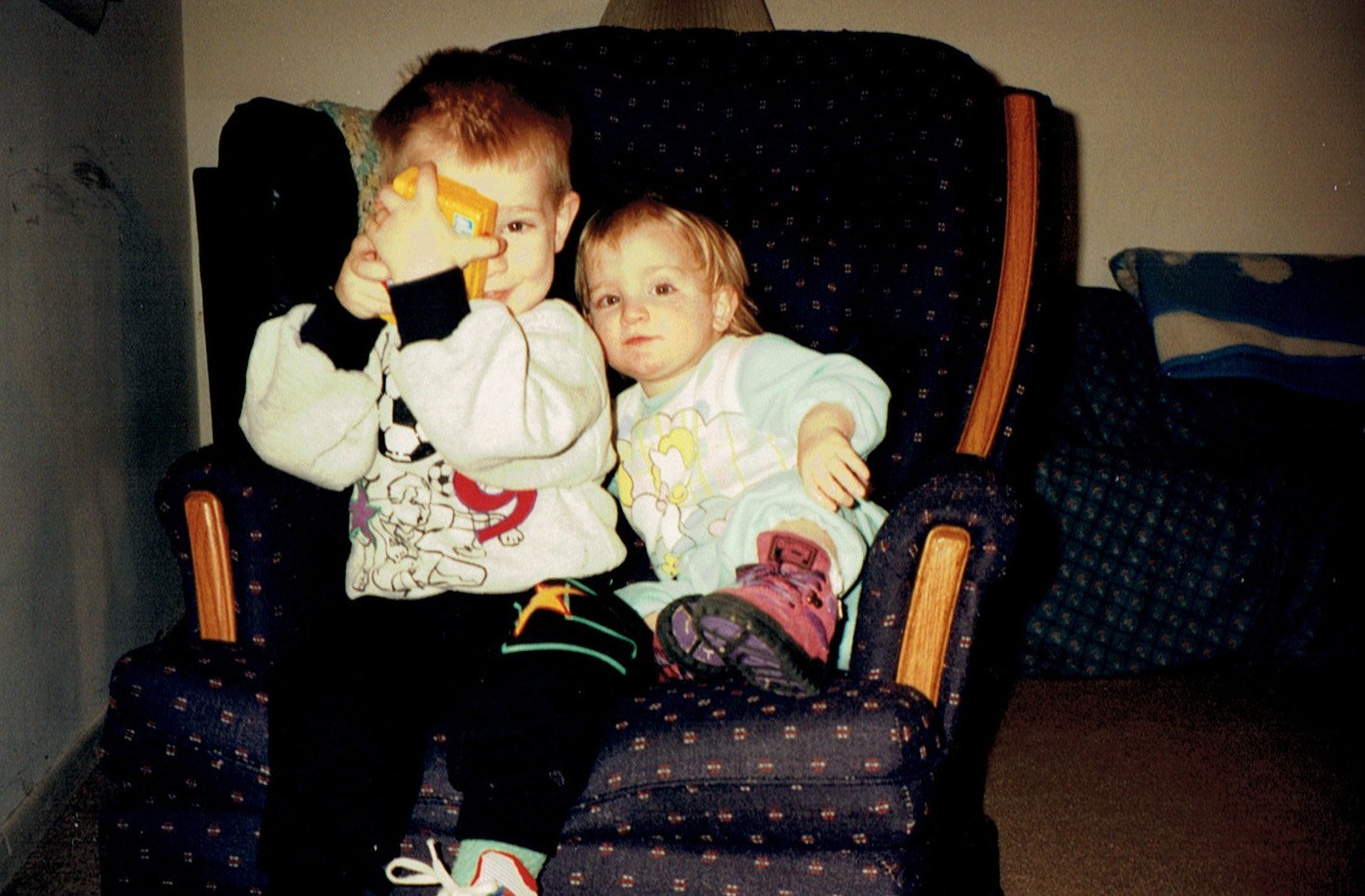Nicholas and Brianna O'Neil are sitting next to each other in a chair.