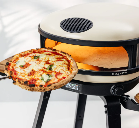 A pizza being cooked in a Gozney pizza oven.